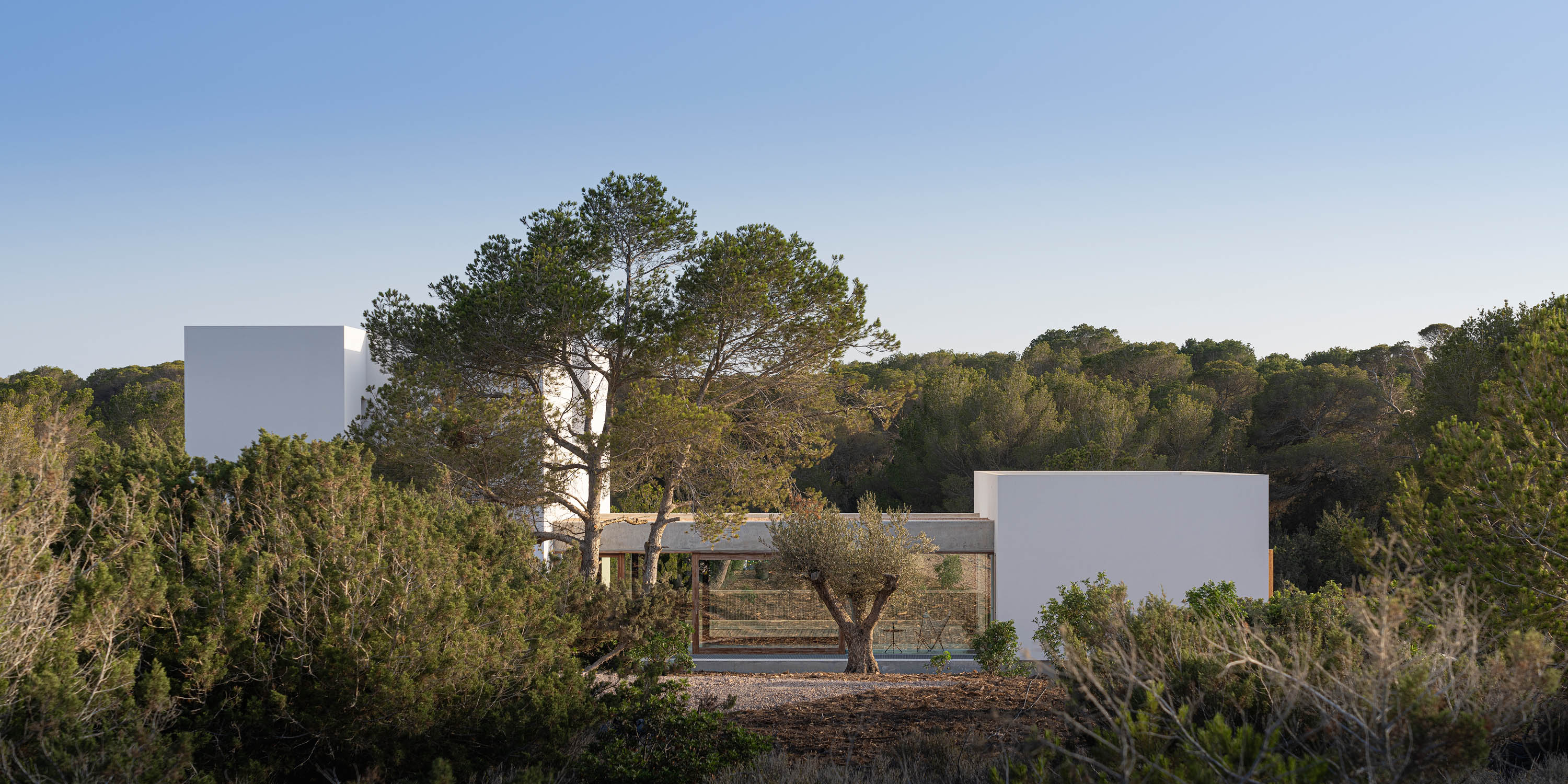 Formentera House by Mari&amp;agrave; Castell&amp;oacute;, a white concrete structure in the countryside
