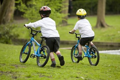 Boys ride shop on bike