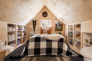 plywood kids bedroom in loft, built in storage, black and white scheme, side tables, artwork, toys, toy storage ideas