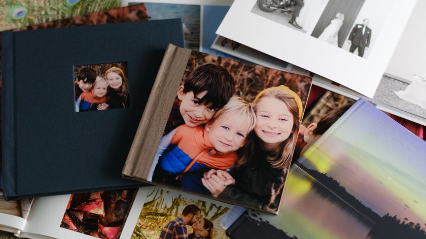 A stack of various photo books on a desk