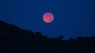 Ash and smoke from the Whittier Fire in California turned the full moon a red-orange color on July 8, 2017.