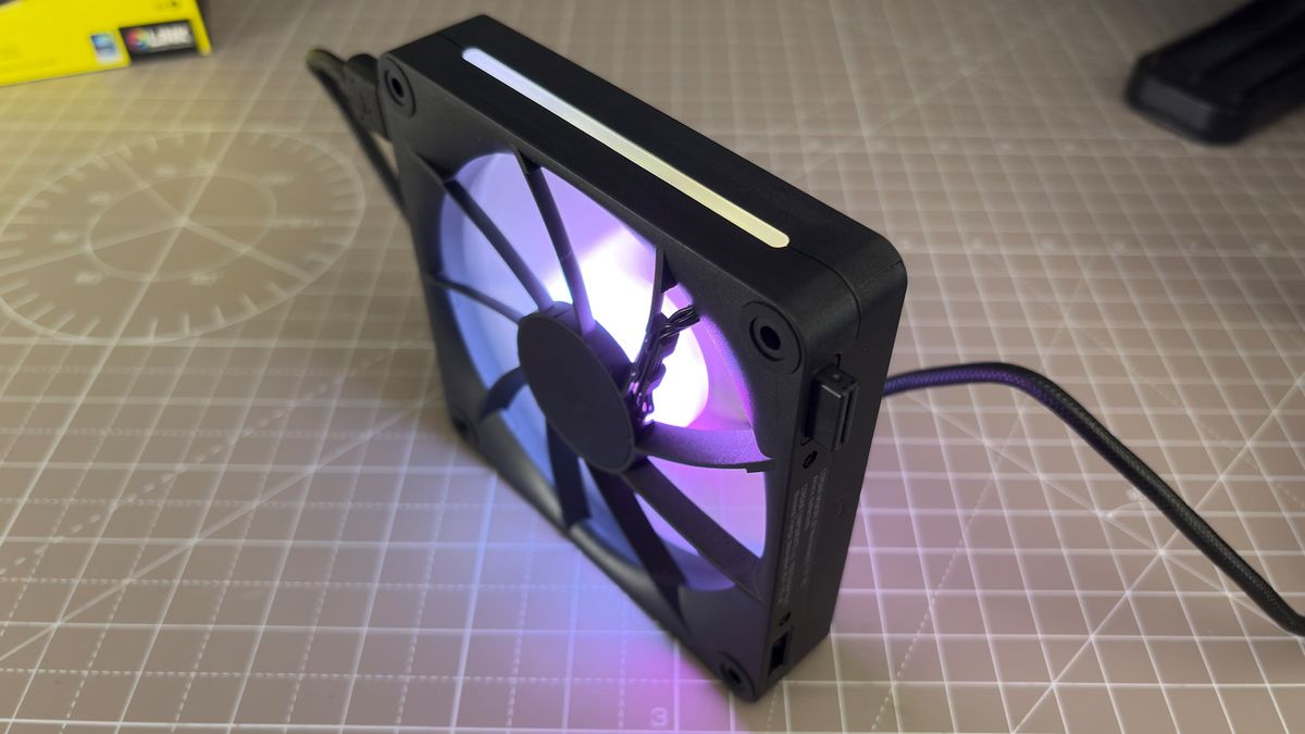 Various PC fans on a table with testing equipment for a round of batch tests.