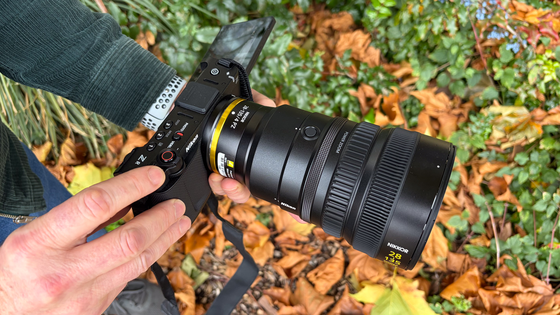 Person holding a Nikon ZR with Z 28-135mm f/4 PZ lens