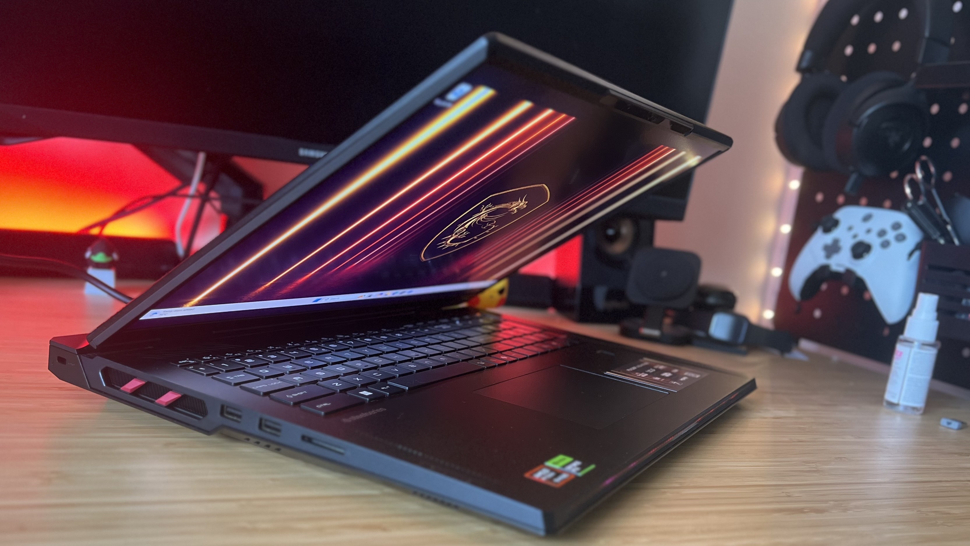 MSI Raider A18 HX gaming laptop with lid slightly closed on a wooden desk