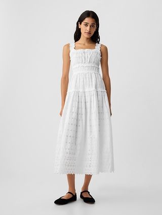 a model wears the gap x doen eyelet midi dress in front of a plain backdrop