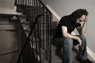 depressed guy sitting on stairs