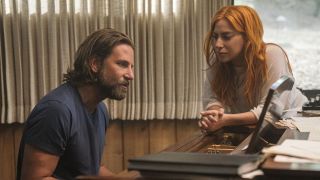 Lady Gaga watching as Bradley Cooper sings while playing piano in A Star is Born