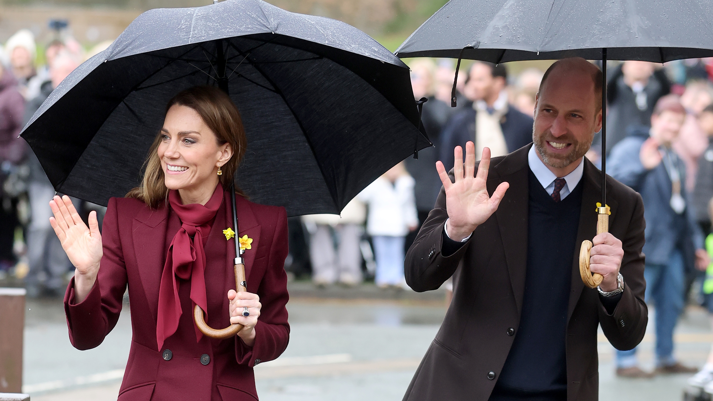 Catherine, Princess of Wales and Prince William, Prince of Wales wave whilst holding umbrellas during a visit to the Oriel Davies on February 26, 2026
