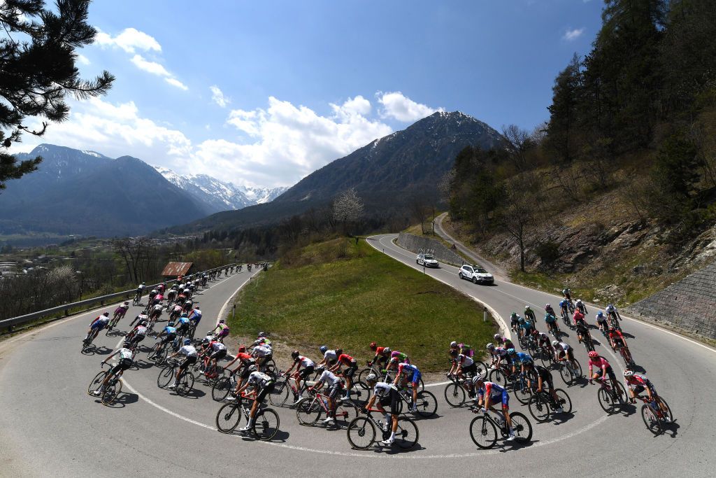 RIVA DEL GARDA ITALY APRIL 23 Kilian Frankiny of Switzerland Connor Brown of New Zealand and Team Qhubeka Assos The Peloton passing through Duron 1000m during the 44th Tour of the Alps 2021 Stage 5 a 1209km stage from Valle del Chiese Idroland to Riva del Garda TourofTheAlps Landscape Mountains Snow TouroftheAlps on April 23 2021 in Riva del Garda Italy Photo by Tim de WaeleGetty Images