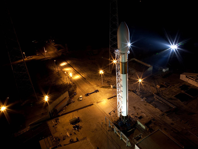 Falcon 9 standing vertically at Cape Canaveral.