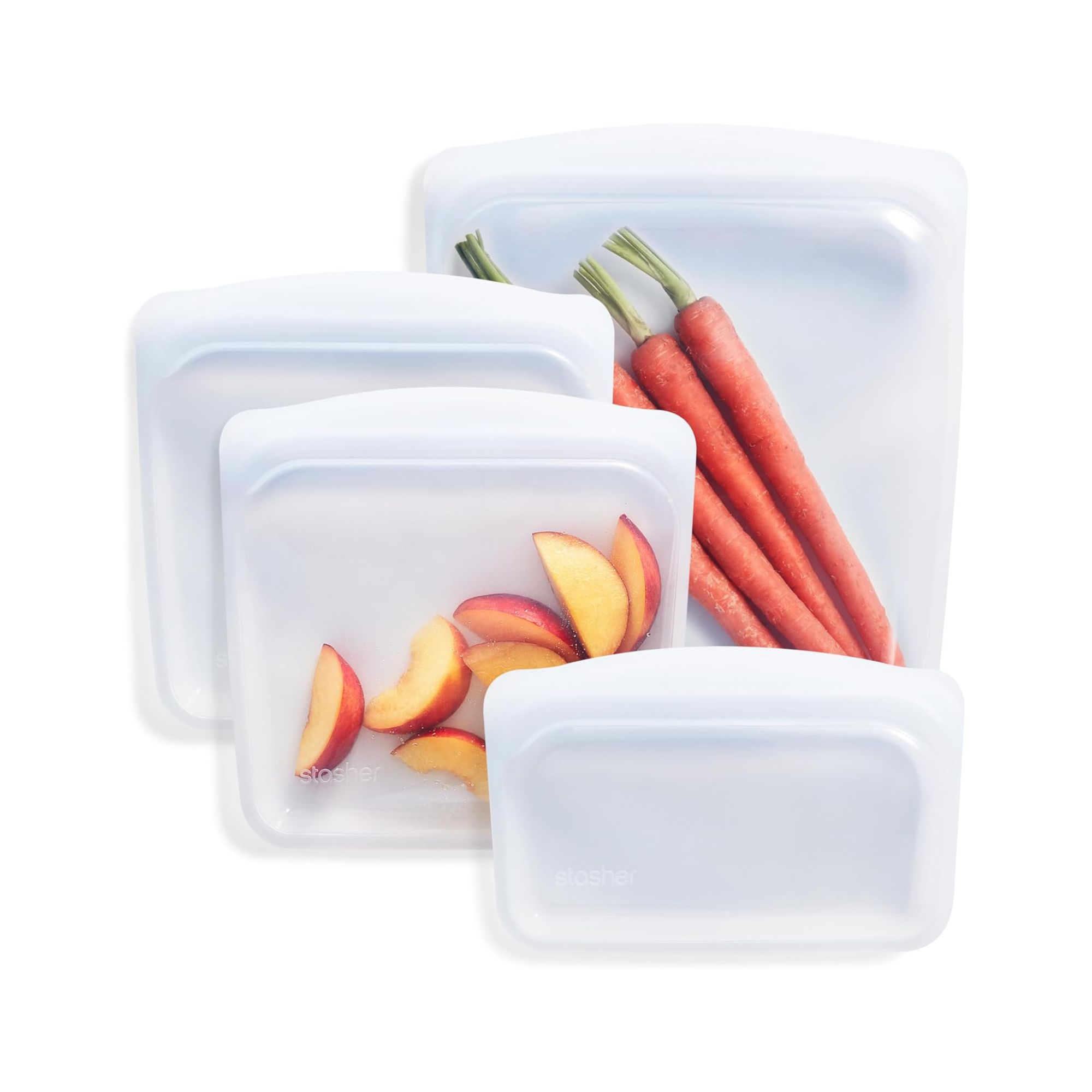 Three clear food bags with peaches and carrots in two of them