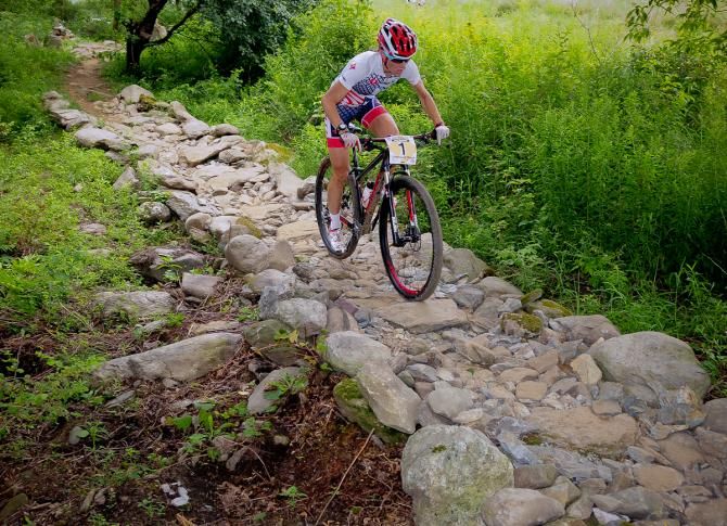 Lea Davison (Specialized) riding a rock garden with the race lead on lap four