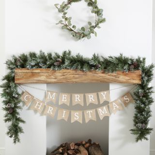 A festive hessian garland with 'Merry Christmas' slogan with festive foliage detail
