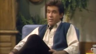 Alan Thicke sits talking in an office in Growing Pains.