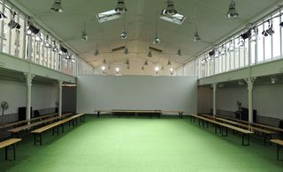 Spartan benches on each side of the space, while the floors were covered in AstroTurf,