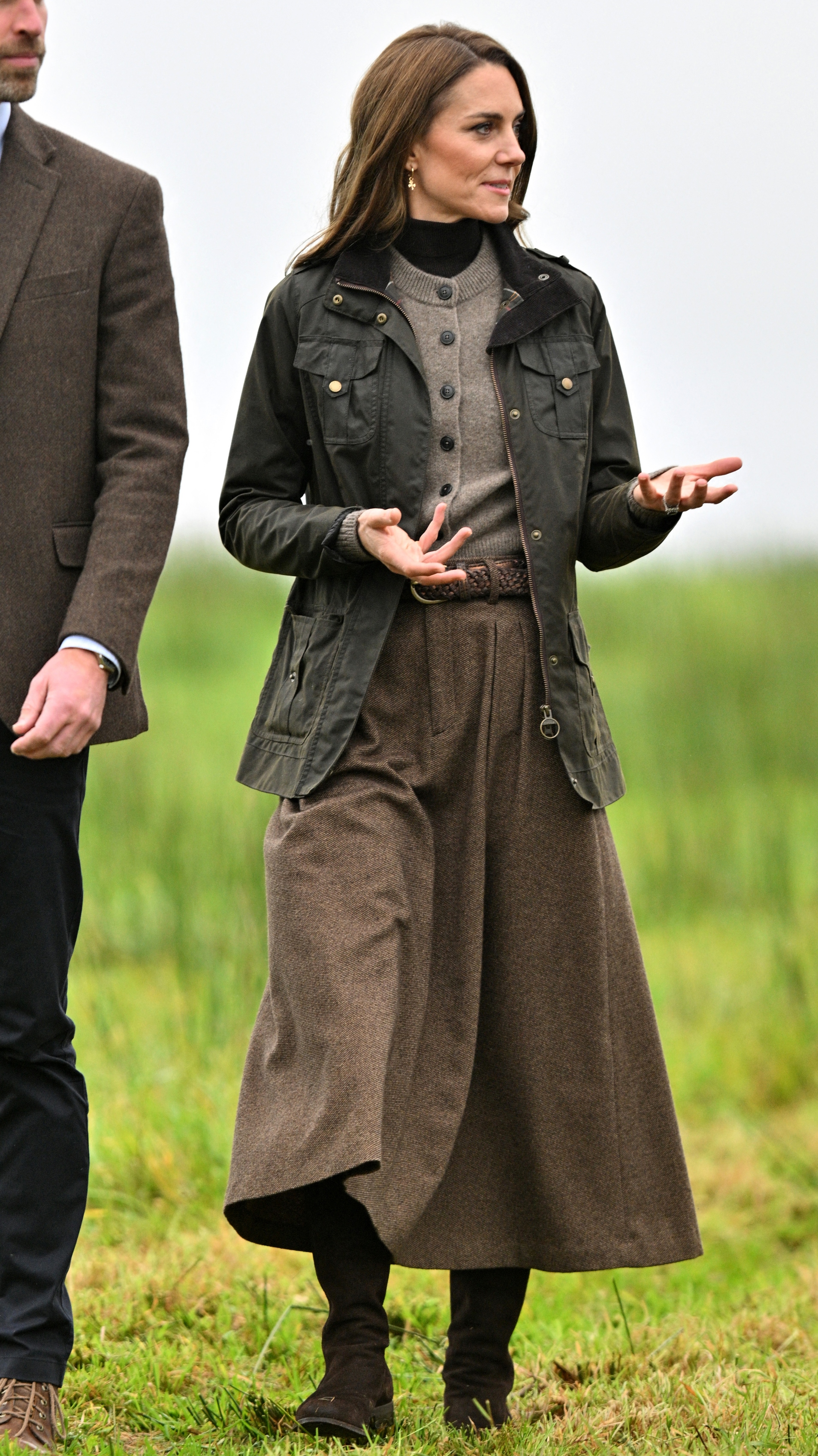 Catherine, Princess of Wales gestures as she speaks with farm owners during a visit to Mallon Farm