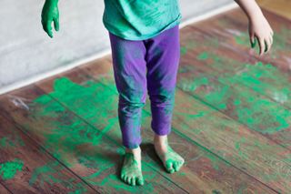 A child covered in green paint