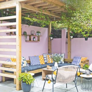 garden patio with pergola and pink wall