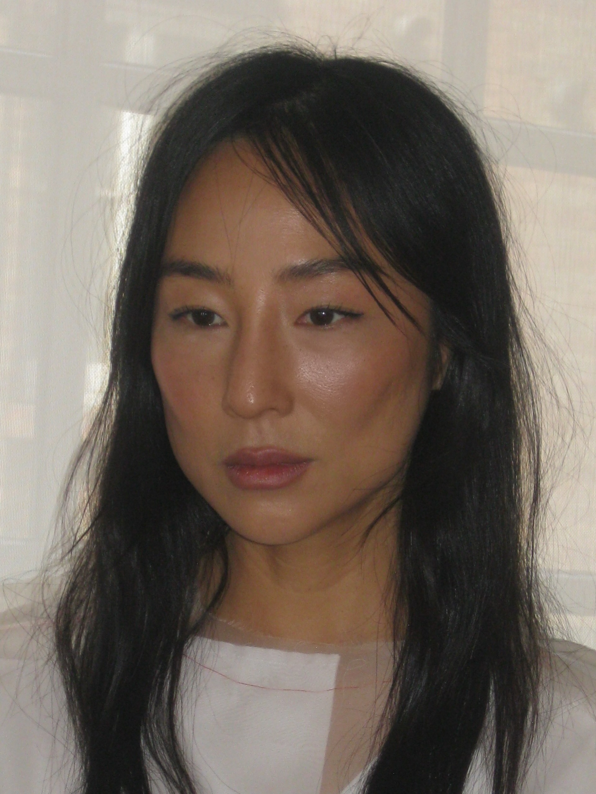 Greta Lee with curtain bangs