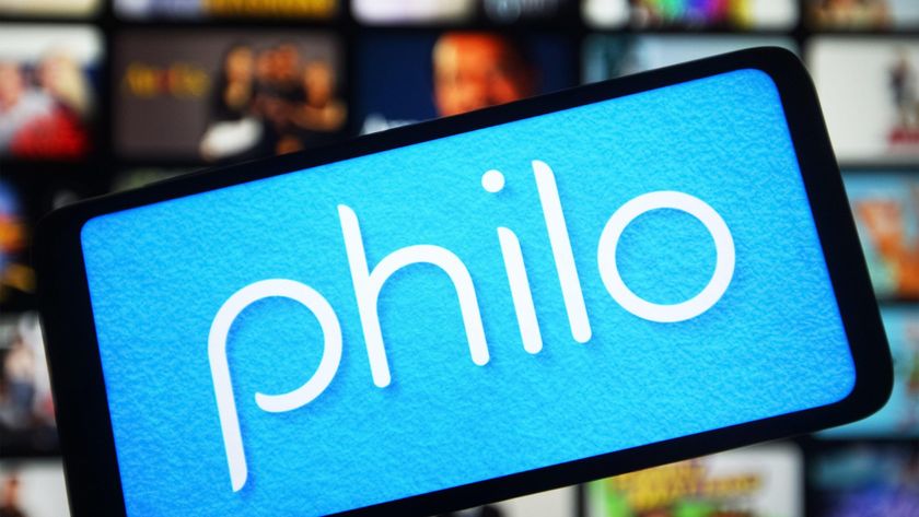 The Philo app shown on a phone in front of a TV