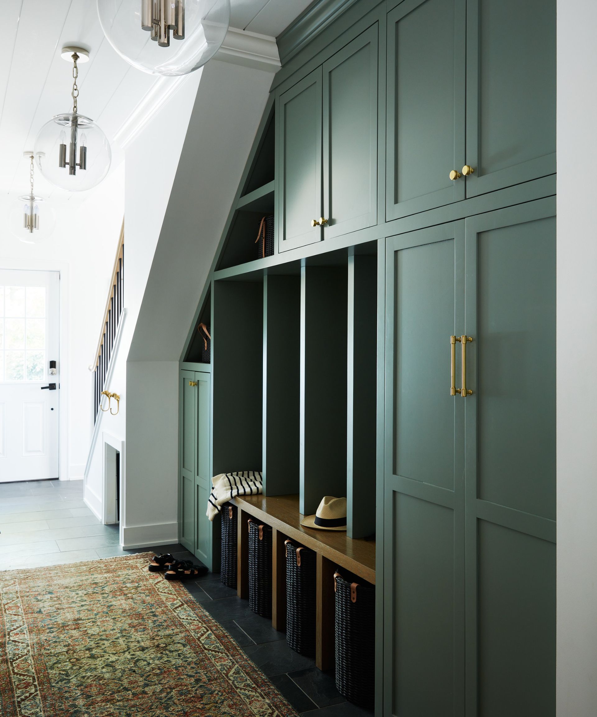 best green paints, green entry way with custom cabinetry, rug, large clear glass pendants