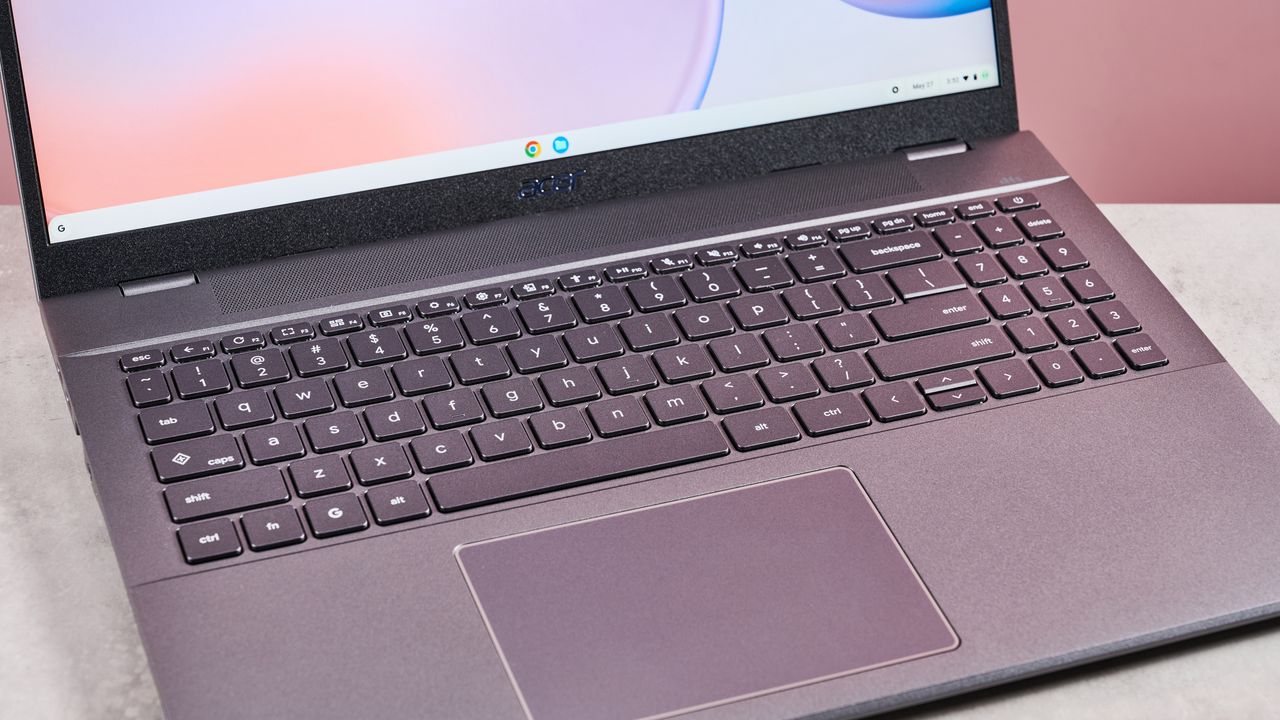 Close-up of keyboard on Acer Chromebook Plus 514, on desk with pink background