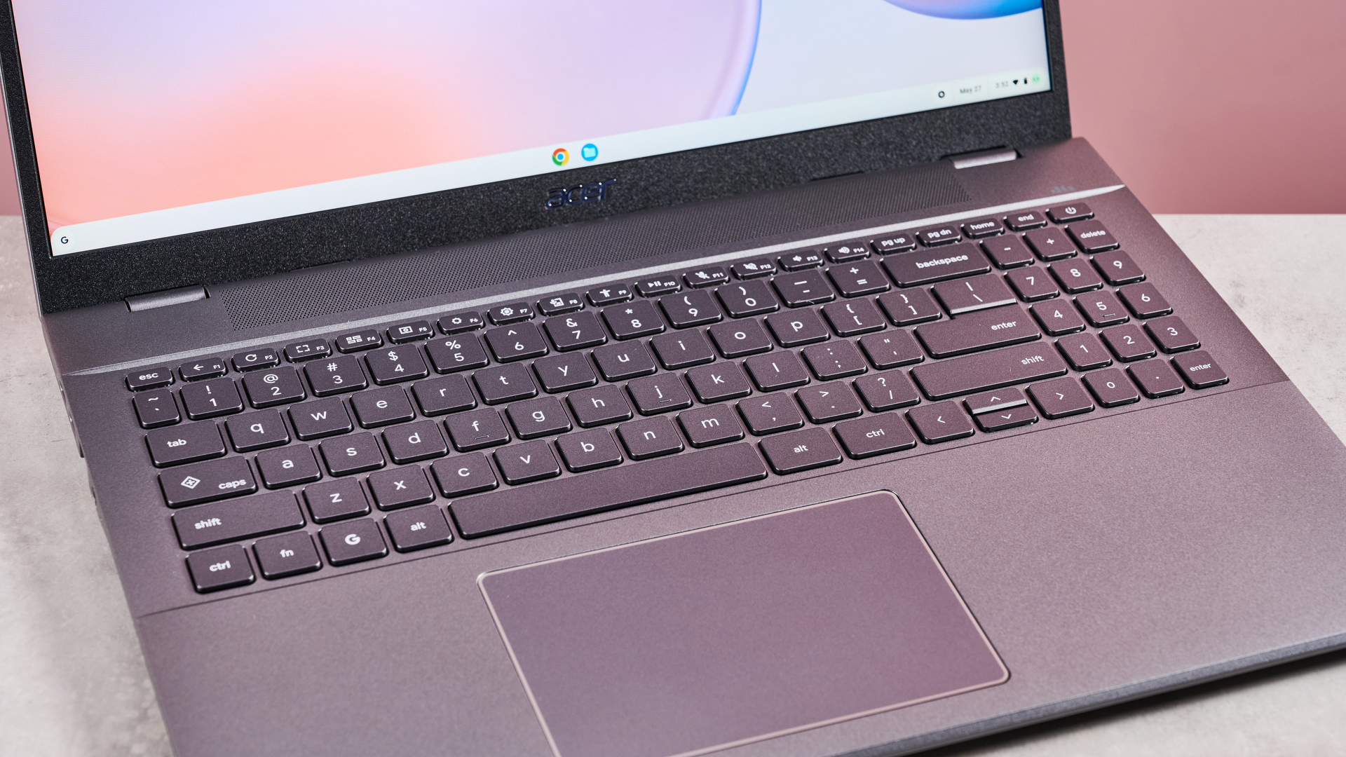 Close-up of keyboard on Acer Chromebook Plus 514, on desk with pink background