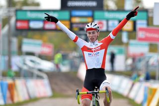 Dutch cyclist Jens Dekker celebrates as he crosses the finish line to win the junior's race at the second stop of the Superprestige cyclocross cycling competition in Zonhoven