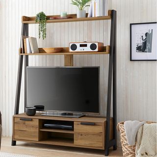 Freestanding wooden TV unit in front of wall panelling