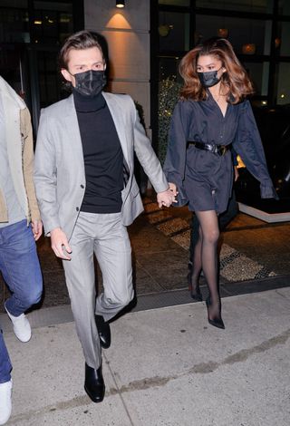 Tom Holland and Zendaya are seen departing their hotel. Zendaya wore an oversized belted shirt.