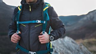 Hiker wearing backpack and GPS watch