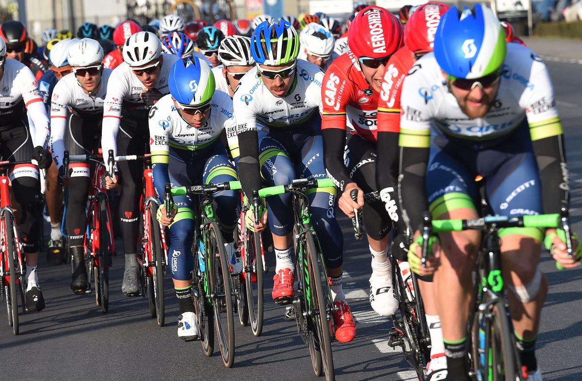 Luke Durbridge leading the peloton with Caleb Ewan tucked in in fifth wheel