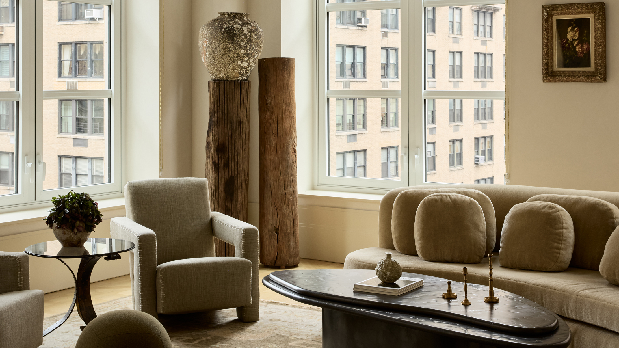 living rom with curved sofa and antique wall art