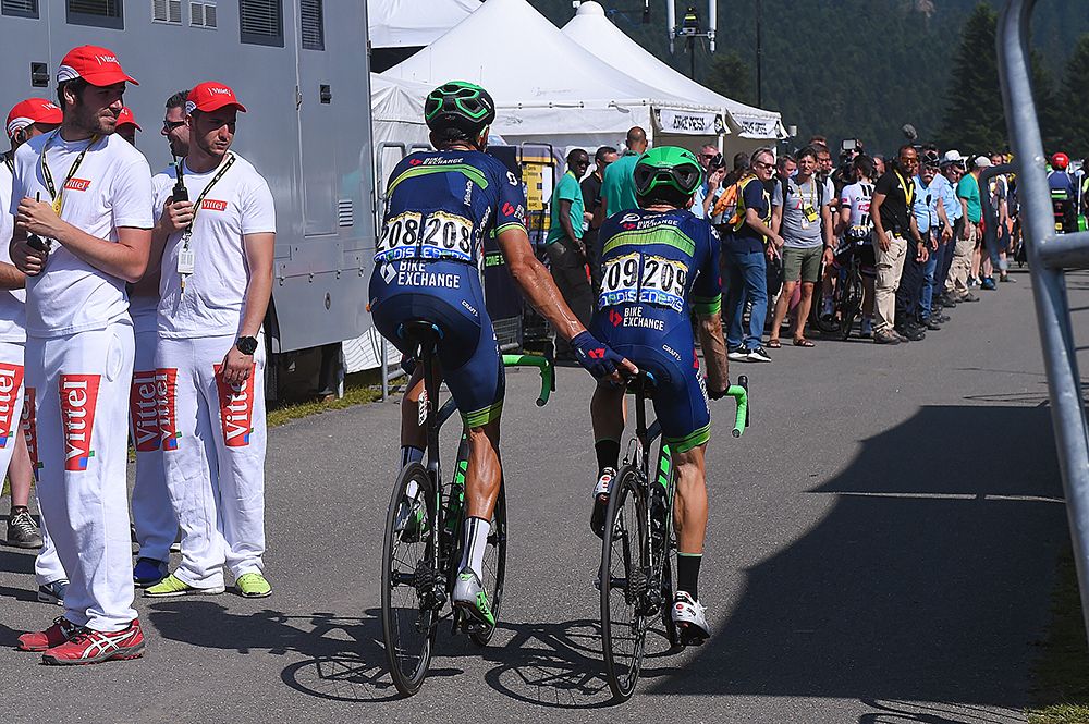 Molina pushes Adam Yates over the finish line after being hit by the collapsed 1km to go banner