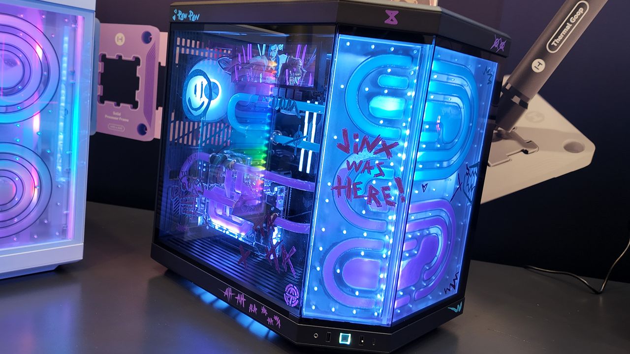 A gaming PC at the Hyte CES 2025 booth with a Bitspower distro plate and themed like Jinx from League of Legends.