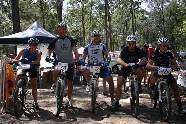 Jason Head (centre, Turramurra Cyclery/T.O.R.C) cuts an impressive figure as he lines up with Craig Gordon (right) and their fellow competitors on the startline.