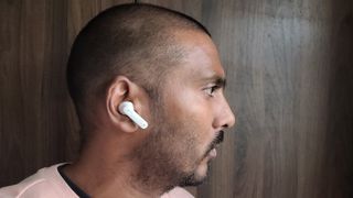 a man wearing the jbl tune 230nc true wireless earbuds