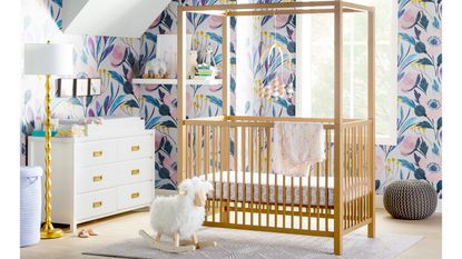 Girls nursery ideas Wooden canopy crib in nursery with printed wallpaper by Wayfair