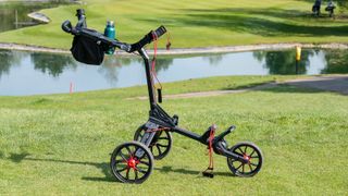 The Bag Boy Nitron Push Cart displayed on the golf course in black