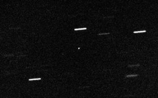 The dot at the center of this image is 'Oumuamua, an object with unusual properties that moved through the solar system in 2017. Scientists never got a much better look at it than this, an issue that has helped seed an ongoing high-profile controversy. This image was taken on OCt. 28, 2017 with the William Herschel Telescope in the Canary Islands.