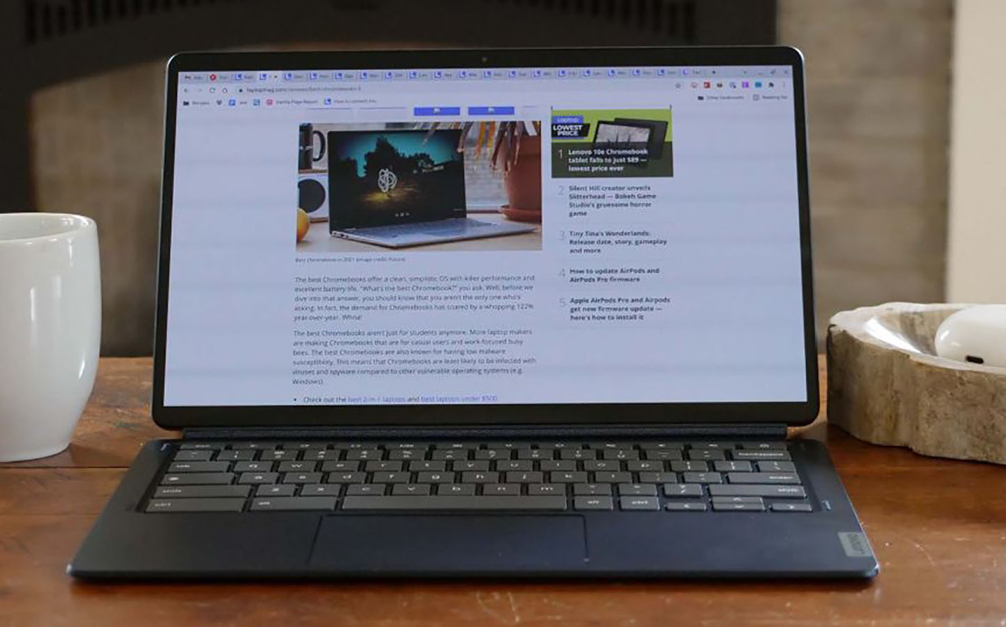 Lenovo Chromebook Duet 5 on a wooden table next to a coffee mug