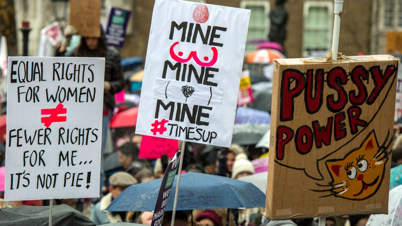 Women&amp;#039;s rights demonstrators hold up placards during the Time&amp;#039;s Up Downing Street protest in January