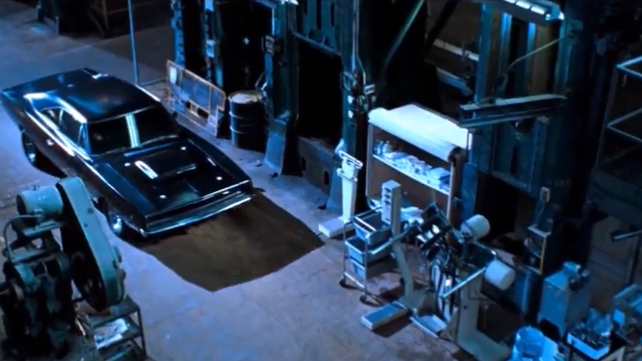 A black charger from above, driving through a warehouse in Blade