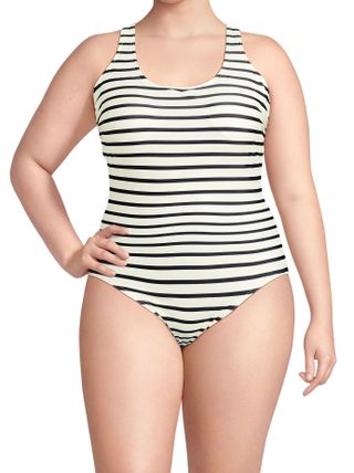 a model wears a striped one-piece swimsuit