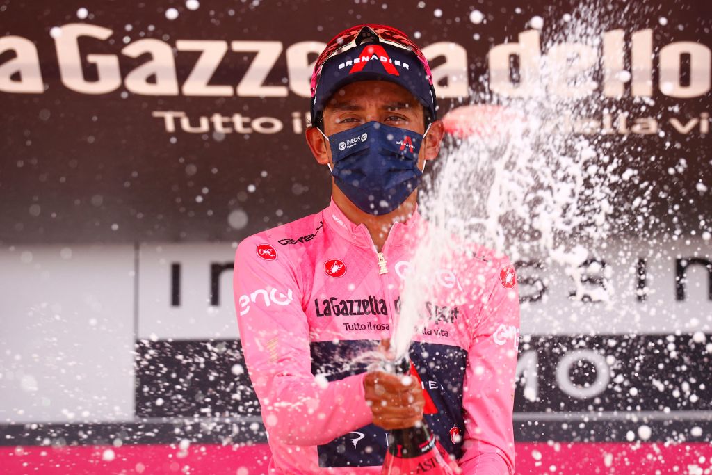 Overlal leader Team Ineos rider Colombias Egan Bernal celebrates on the podium after the 19th stage of the Giro dItalia 2021 cycling race 166km between Abbiategrasso and Alpe di Mera on May 28 2021 Photo by Luca Bettini AFP Photo by LUCA BETTINIAFP via Getty Images