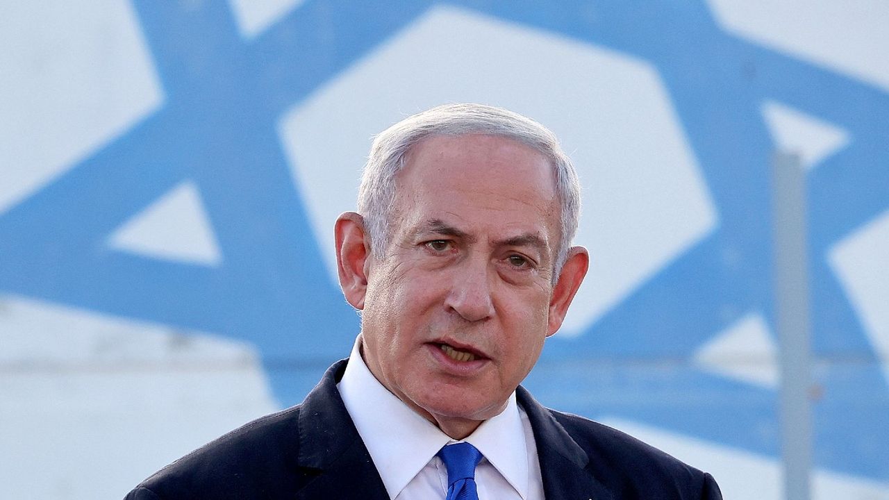 Israel&#039;s Prime Minister Benjamin Netanyahu delivers a speech in front of a blue star of David