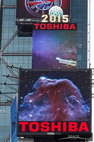 An image of the Horsehead Nebula, taken by the Hubble Space Telescope appears on the lower of two screens in Times Square shoing Hubble-related images through April 26. On the top screen, a shot featuring the telescope.