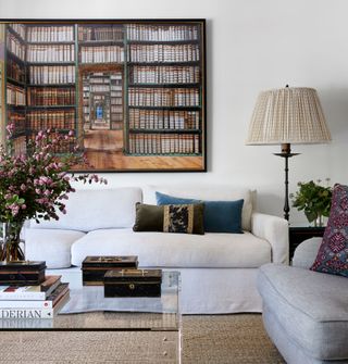 White sofas, library picture, wicker rug