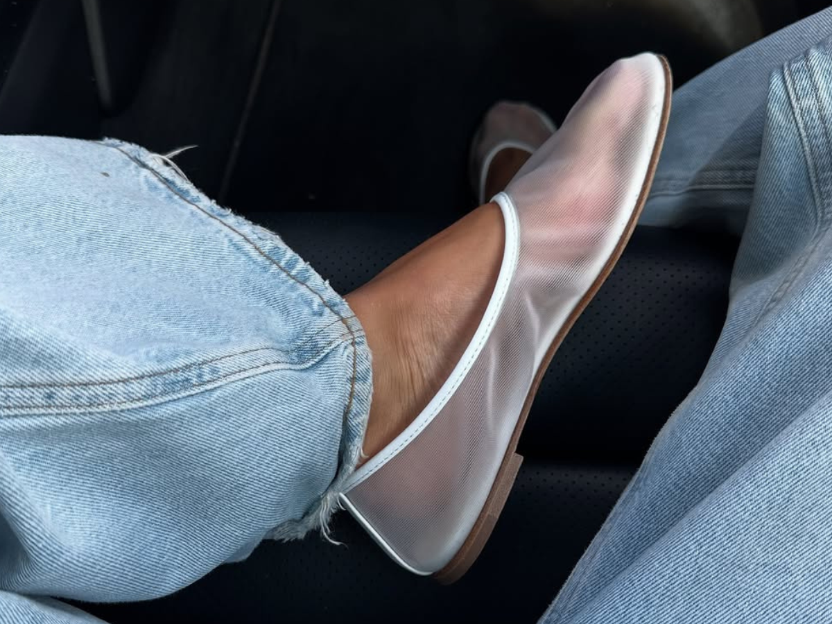 Woman wearing jeans and mesh ballet flats.