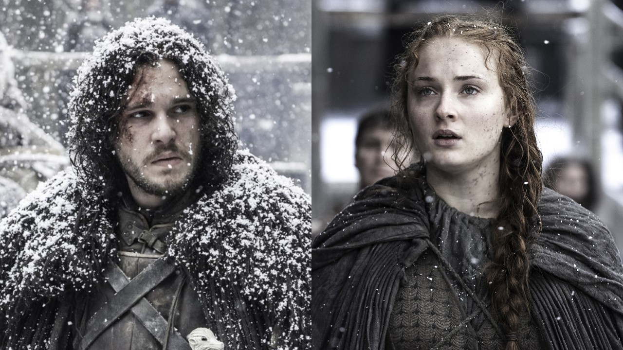From left to right: Kit Harington as Jon Snow in the snow and Sophie Turner as Sansa standing in light snow on Game of Thrones. 